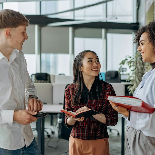 Diverse group of people smiling in a modern office.